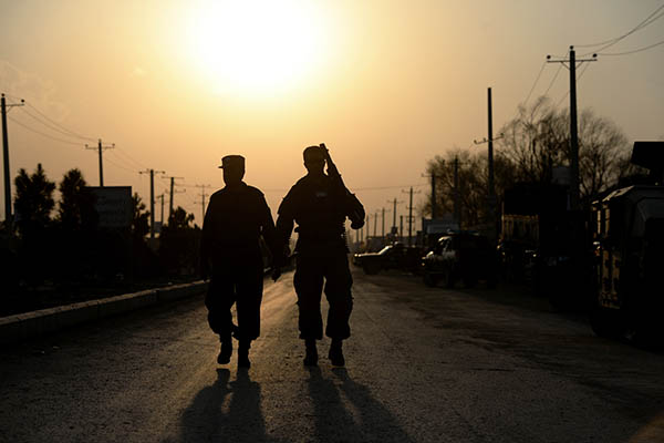 Afghan policemen on patrol after an insurgent attack. Wakil Kohsar—AFP
