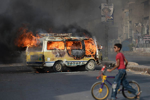 A truck set on fire by protesters after news broke of Altaf Hussain’s arrest in London. Asif Hassan—AFP