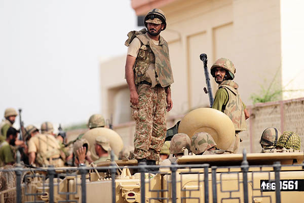 Army personnel stand guard at the Karachi airport after an assault that left at least 35 dead. Rizwan Tabassum—AFP