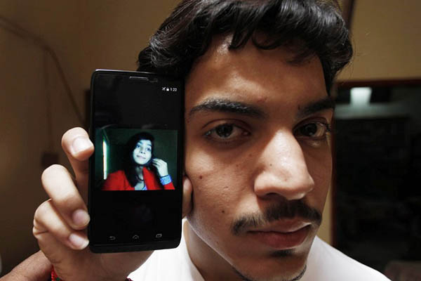 Hassan Khan shows a picture of his deceased wife, Zeenat Bibi. AFP