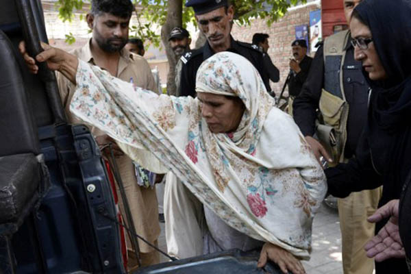 Police escort Perveen Bibi to court in Lahore. Arif Ali—AFP