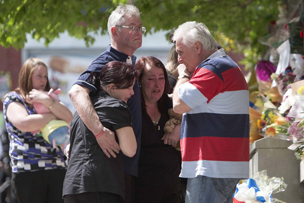 Lee Rigby’s family mourns at the site of his attack. AFP