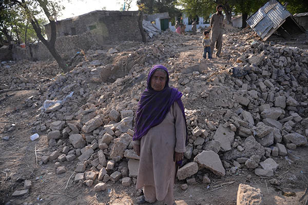 Mirjan stands in front of the rubble that used to be her house. Aamir Qureshi—AFP